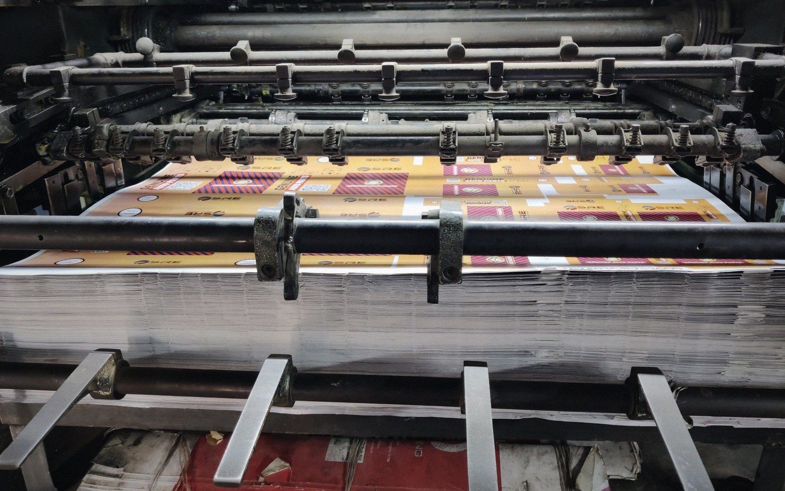 A printed offset lithography sheet showing multiple record sleeve panels in register, fresh from the press, colours slightly over-saturated before trimming